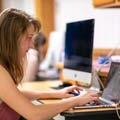 A student works on a laptop in class